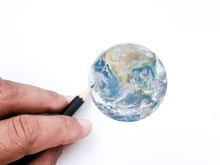 Hands are drawing the earth representing conservation.  Elements of this image furnished by NASA.