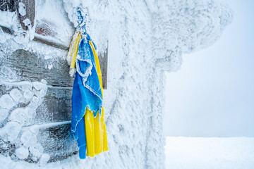 Icy ukrainian flag hanging on mountain