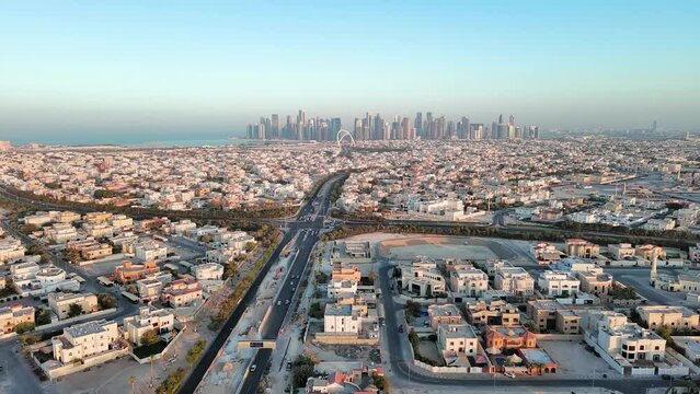 Doha, Qatar: Aerial view of city skyline of West Bay, cityscape with modern buildings (skyscrapers) with clear blue sky behind them - landscape panorama of Arabian Peninsula from above, West Asia