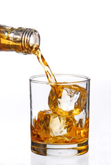 pouring iced whisky glass on white background.