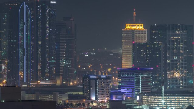 Rows of skyscrapers in financial district of Dubai aerial night timelapse.