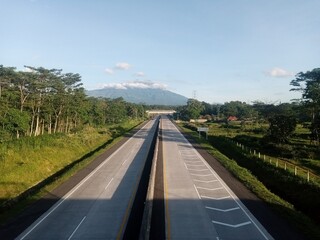 Photo of rigid pavement on a concrete road on a highway in the middle of the wilderness with a...