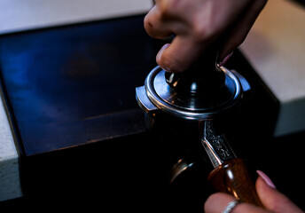 coffee grinder grinding coffee pouring into a portafilter