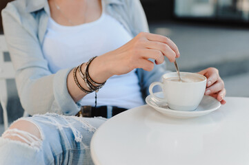Woman enjoying coffee in the morning. Breakfast in a cafe