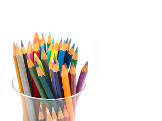 Variety of colored pencils in a glass isolated on white background and copy space. spot focus.