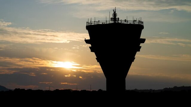 Air Traffic Control Tower in International Passenger Airport, Time Lapse at Sunrise with Colorful Clouds