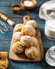 Homemade coconut cookies on a serving board on a blue wooden culinary background	