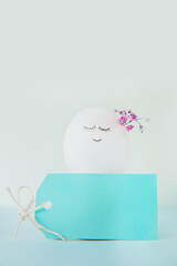 Easter eggs with painted face as concept for festive spring card..