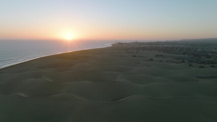 Sand dunes meet the Atlantic Ocean. Top view of Maspalomas sand dunes.