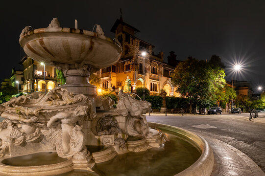 Neighborhood coppede detail of the fountain of the frogs at night after the restoration. The street lights illuminate the little fairy house. Center of Rome Trieste district. Italy.