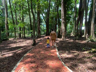 child and mother walking in the park
