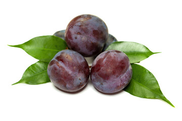 Plum with green leaves isolated on white background