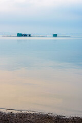 Fishing raft house on the lake in the misty morning. Dong Nai province, Vietnam