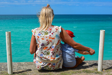 A Cuban girl and a Cuban boy admire the azure water of the ocean. Varadero Cuba 2019