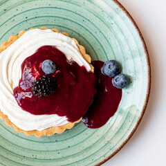 Cheesecake tart with berry jam and blueberries