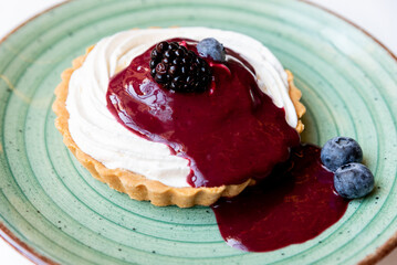 Cheesecake tart with berry jam and blueberries