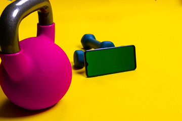 Dumbbells space kettlebell yellow phone lue isolated background cast, for lifting dumbbell from...