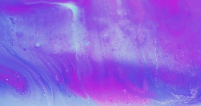 Color fluid mix. Glitter ink wave. Floating paint. Blur iridescent purple pink blue liquid flow motion abstract art background shot on RED Cinema camera.