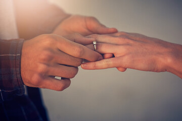 Its time for the next step. Cropped shot of a young man putting an engagement ring on his girlfriends finger.