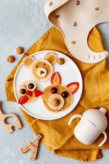 Animal Shaped Pancake with strawberry and fruit for kids. Plate with funny pancake. Funny breakfast idea for children. Kids meal. Flat Lay