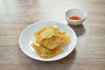 crispy fried dumpling paste stuffed chop pork dipping sweet chili sauce on plate