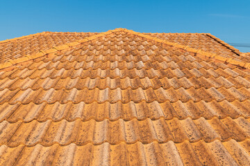 Old orange roofs ruined. Texture of a roof with old roof tiles.top piece of house. roof in perfect condition.
