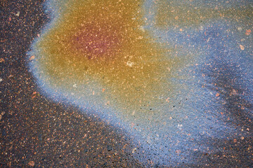Fototapeta na wymiar Oil stain, Gas Stain drop from the Car on the Parking Lot Floor