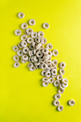 dry breakfast, flakes in the form of rings on a yellow background