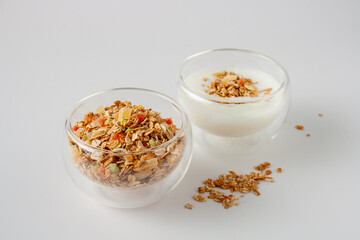 cereal muesli and glass with yogurt on white background