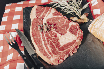 Raw beef meat on a dark wooden board.