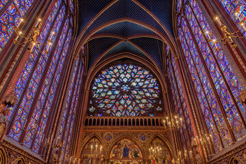 The rose window and the colorful stained glass side windows of the gothic Sainte-Chapelle in Paris, France