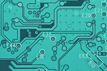 Hard drive HDD printed wiring board PWB closeup. Conductive patterns. Turquoise PC background. Bright teal tinted computer wallpaper. Science and digital technologies. Strong macro
