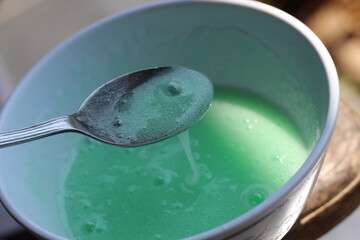 Spoon with avocado cream sauce