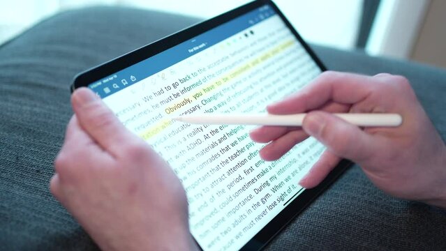 Underlining Yellow Highlighting Text on a Tablet With Stylus Pencil