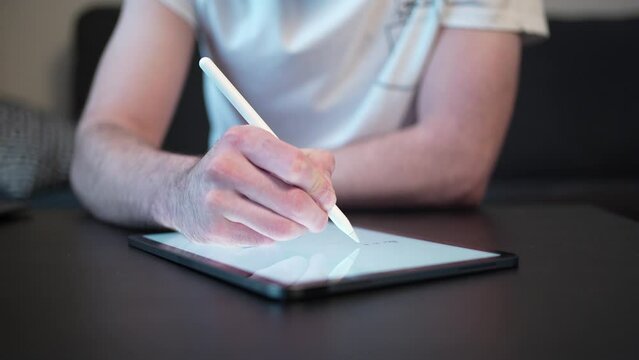 Working Taking Notes on a Digital Tablet  With a Stylus Pen Closeup