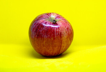 Red apple portrait on a yellow background