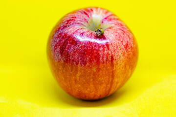 Red apple portrait on a yellow background