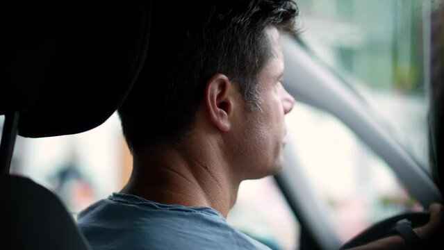 Man driving car in slow-motion pensive person driver
