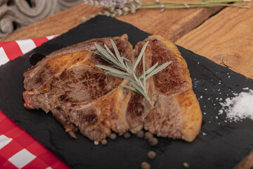 Beef on a slab of dark stone.