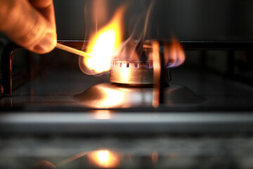 Gas stove, some stoves lit with a match with fire, to cook a good meal in the kitchen