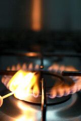Gas stove, some stoves lit with a match with fire, to cook a good meal in the kitchen