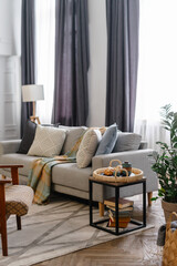 Comfortable living room in retro style with breakfast tray near couch