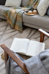 Open book lying on retro style armchair
