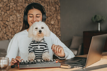 Music creation on midi keyboard with dog maltese
