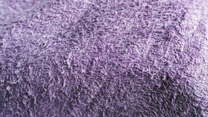 Violet old terry cloth texture background. Pale purple color terry cotton towel close up view. Household bath towelling cloth, used towel closeup texture
