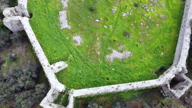 Marvelous aerial view flight Overfly drone footage of a castle ruins of a byzantine fortress of 13th century wild nature Corfu Greece. 4k Cinematic view from above by Philipp Marnitz spring 2022