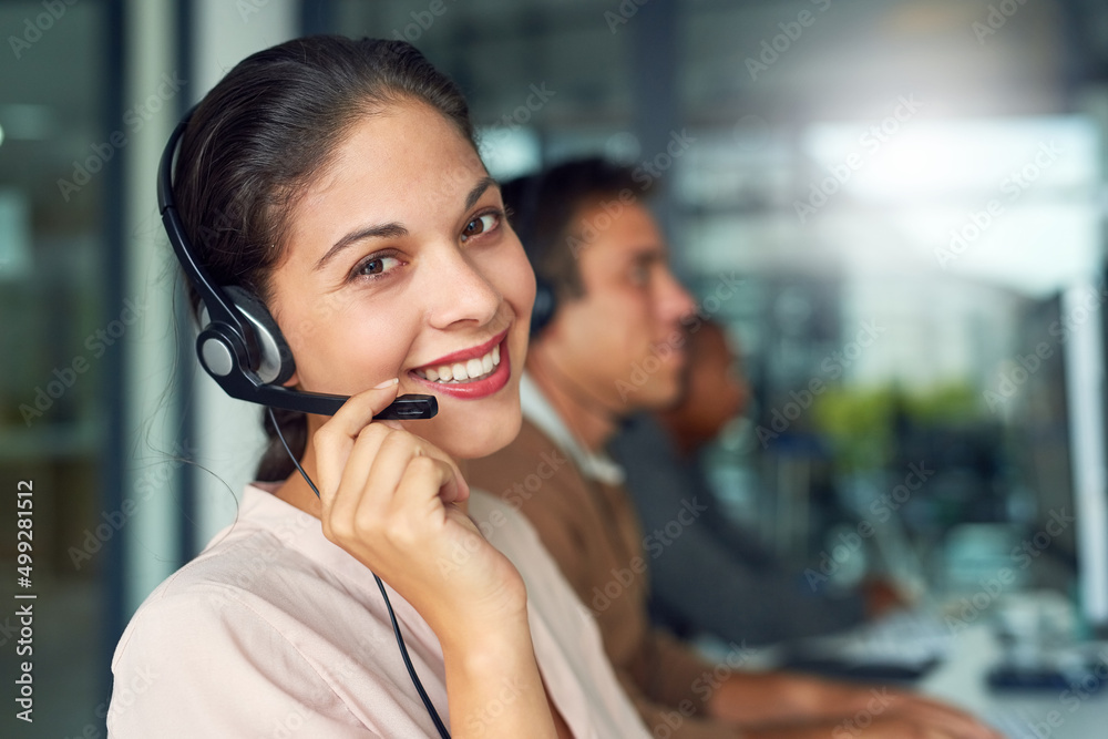 Poster excellent customer service goes a long way. portrait of a call centre agent working in an office wit