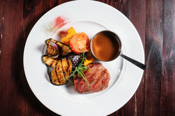 Steak grilled with vegetables top view.