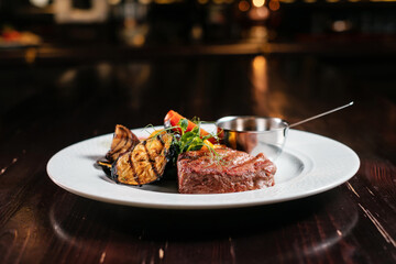 Steak grilled with vegetables side view.