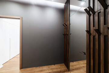 Interior design of the house. Wood wardrobe and black walls